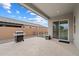 This covered patio has neutral colors, an outdoor grill, and a view of the backyard at 20954 E Camacho Ct, Queen Creek, AZ 85142