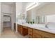 Bathroom featuring double sinks, large mirror, and plenty of cabinet space at 21629 N Dietz Dr, Maricopa, AZ 85138