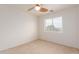 Bedroom featuring neutral walls, carpet, ceiling fan and a large window at 21629 N Dietz Dr, Maricopa, AZ 85138