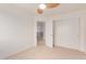 Bright bedroom features a ceiling fan, closet with sliding doors, and neutral carpet flooring at 21629 N Dietz Dr, Maricopa, AZ 85138