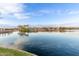 Scenic pond with clear blue water, island waterfall feature and waterfront homes at 21629 N Dietz Dr, Maricopa, AZ 85138