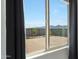 Window view of the backyard, showcasing desert landscaping, a block wall, and mountain views at 21889 N 259Th Ave, Buckeye, AZ 85396