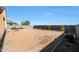 Large backyard with desert landscaping, a low block wall, and potential for customization at 21889 N 259Th Ave, Buckeye, AZ 85396