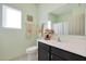 Bathroom with a dark vanity, stylish mirror, and fresh, clean decor at 21889 N 259Th Ave, Buckeye, AZ 85396