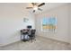 A bright bedroom with carpet and a computer desk in front of a window that offers natural light at 21889 N 259Th Ave, Buckeye, AZ 85396