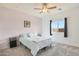 A peaceful bedroom featuring plush bedding, soft colors, and natural light from a window at 21889 N 259Th Ave, Buckeye, AZ 85396