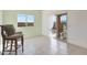 Light-filled dining room featuring tile floors, window, sliding glass door, and counter stools at 21889 N 259Th Ave, Buckeye, AZ 85396