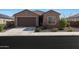 Charming single-story home with a well-manicured front yard and a two-car garage at 21889 N 259Th Ave, Buckeye, AZ 85396