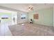 Open concept living room with carpet, a ceiling fan, and an adjacent dining area at 21889 N 259Th Ave, Buckeye, AZ 85396