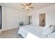 Bright bedroom features a ceiling fan, neutral walls, and soft carpet at 21889 N 259Th Ave, Buckeye, AZ 85396