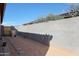 Practical side yard with concrete block wall, providing privacy and defined space at 21889 N 259Th Ave, Buckeye, AZ 85396