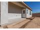 Exterior view of home's backyard with door, covered patio, and new landscape waiting for its new owner's personal touch at 2227 W Cambridge Ave, Phoenix, AZ 85009