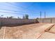 Wide angle of home's backyard with new gray block fence, fresh landscape, ready to become someone's dream at 2227 W Cambridge Ave, Phoenix, AZ 85009