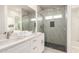 A bathroom featuring double sinks and a glass-walled shower at 2227 W Cambridge Ave, Phoenix, AZ 85009