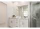 A bright bathroom featuring double sinks and a shower at 2227 W Cambridge Ave, Phoenix, AZ 85009