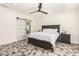 This bedroom features a ceiling fan, sliding door, and geometric tile flooring at 2227 W Cambridge Ave, Phoenix, AZ 85009