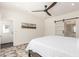 A bedroom with a painting, door to the outside, and sliding door to the bathroom at 2227 W Cambridge Ave, Phoenix, AZ 85009