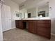 Bathroom with a long vanity, a large mirror, and dark wood cabinets for ample storage at 2344 E Alida Trl, Casa Grande, AZ 85194