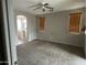 Spacious bedroom featuring neutral carpet, ceiling fan, and two windows with wooden blinds at 2344 E Alida Trl, Casa Grande, AZ 85194