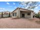 This backyard includes a covered patio and low maintenance landscaping at 24118 W Desert Bloom St, Buckeye, AZ 85326