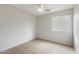 Bedroom features tile flooring, window and ceiling fan at 24118 W Desert Bloom St, Buckeye, AZ 85326