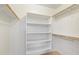 Walk in closet with shelving and wood railing at 24118 W Desert Bloom St, Buckeye, AZ 85326