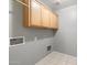 Utility room with built-in cabinets and tile flooring at 24118 W Desert Bloom St, Buckeye, AZ 85326