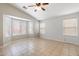 Living room bathed in natural light with tile flooring and vaulted ceilings at 24118 W Desert Bloom St, Buckeye, AZ 85326