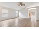 Bright living room with tile flooring, ceiling fan, and neutral color palette at 24118 W Desert Bloom St, Buckeye, AZ 85326