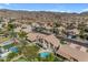 Aerial view of a backyard with a pool, lush landscaping, and a beautiful neighborhood at 2419 E Goldenrod St, Phoenix, AZ 85048