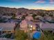 Charming desert home with a tile roof, landscaped yard, and mountain views at dusk at 2419 E Goldenrod St, Phoenix, AZ 85048