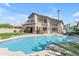 Inviting backyard with a sparkling pool, lush lawn, and cozy patio area, perfect for outdoor living at 2419 E Goldenrod St, Phoenix, AZ 85048