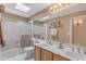 Bathroom with dual vanity sinks, shower over tub, and a skylight for plenty of natural light at 2419 E Goldenrod St, Phoenix, AZ 85048