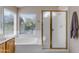 Bathroom featuring a soaking tub under a window and a separate shower with gold-trimmed glass doors at 2419 E Goldenrod St, Phoenix, AZ 85048