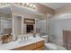 Well-lit bathroom featuring a mirrored wall, framed mirror, and a shower with glass door at 2419 E Goldenrod St, Phoenix, AZ 85048