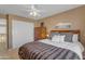 Bedroom with a large bed and neutral colored walls with a double door closet to the left at 2419 E Goldenrod St, Phoenix, AZ 85048