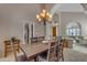 Spacious dining room with a rustic wooden table, seating for six, and an elegant chandelier at 2419 E Goldenrod St, Phoenix, AZ 85048