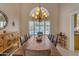 The dining room has a long wooden table, a decorative chandelier, and a view of the pool at 2419 E Goldenrod St, Phoenix, AZ 85048