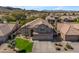 Expansive home featuring a well-maintained lawn, desert landscaping, and a three car garage at 2419 E Goldenrod St, Phoenix, AZ 85048