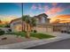 Charming two-story home featuring a well-manicured lawn and a three-car garage at 2419 E Goldenrod St, Phoenix, AZ 85048