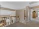 Upstairs hallway with neutral tones and railing overlooking the lower level at 2419 E Goldenrod St, Phoenix, AZ 85048