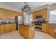 Well-lit kitchen with stainless steel appliances, granite countertops, and a functional center island at 2419 E Goldenrod St, Phoenix, AZ 85048