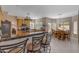 Open kitchen with a breakfast bar, connecting to a cozy breakfast nook in a bright, inviting space at 2419 E Goldenrod St, Phoenix, AZ 85048