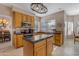 Bright kitchen featuring a center island, stainless steel appliances, and warm wood cabinetry at 2419 E Goldenrod St, Phoenix, AZ 85048