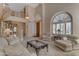 Bright living room with high ceilings, a grand staircase, and comfortable seating, perfect for entertaining guests at 2419 E Goldenrod St, Phoenix, AZ 85048