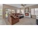 Cozy living room features a fireplace, comfortable seating, and natural light streaming through sliding glass doors at 2419 E Goldenrod St, Phoenix, AZ 85048