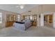 This spacious main bedroom is complete with carpet, vaulted ceilings, and lots of natural light at 2419 E Goldenrod St, Phoenix, AZ 85048