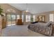 Bright main bedroom with large windows, sliding glass door, and a neutral color palette at 2419 E Goldenrod St, Phoenix, AZ 85048