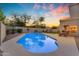 Inviting backyard with a sparkling pool and beautiful sunset views, perfect for relaxation and entertaining at 2419 E Goldenrod St, Phoenix, AZ 85048