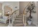 Elegant staircase with carpeted steps and decorative plants for a welcoming ambiance at 2419 E Goldenrod St, Phoenix, AZ 85048